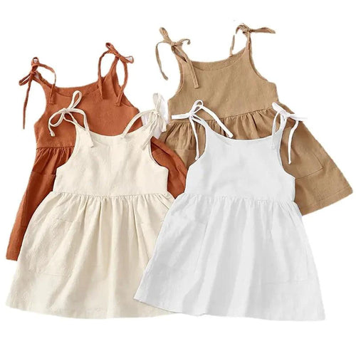 Toddler wearing a white Cotton Chic sundress by MANDOTOS, featuring a sleeveless design and lightweight cotton fabric for warm weather.