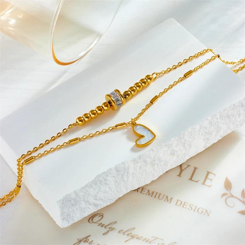 Mandotos boho love heart ankle chain with double-layer chain, charm, tassel, and foot chain design for women's party jewelry accessories.
