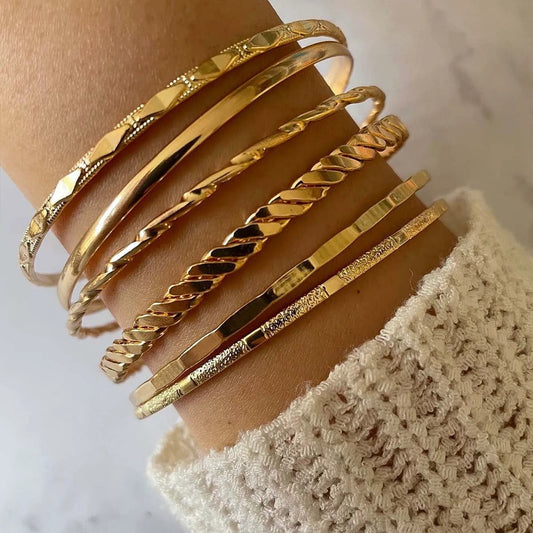 Mandotos Bohemian metal chain bracelet set for women with six gold-colored geometric thick link bangles on a white background.