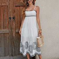 Women's cotton embroidered midi dress by Mandotos, black and white A-line sundress with contrast trim, ideal for vacation wear.