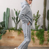 Women's long-sleeved hoodie set by MANDOTOS, featuring a comfortable hoodie and matching pants in soft fabric.