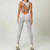 Mandotos women's yoga jumpsuit with V-shaped back, sleeveless design, stretchy fitness and running tights for active wear.