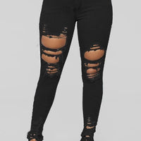 Mandotos women's denim pencil pants with ripped holes, slim fit, long design, and stretch feet for a stylish look.