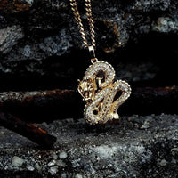 Elegant gold zircon dragon pendant by MANDOTOS featuring detailed dragon design and sparkling zircon accents.