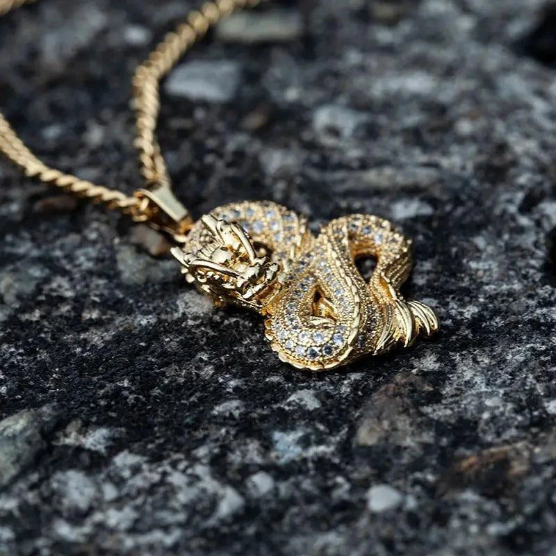 Elegant gold zircon dragon pendant by MANDOTOS featuring detailed dragon design and sparkling zircon stones.