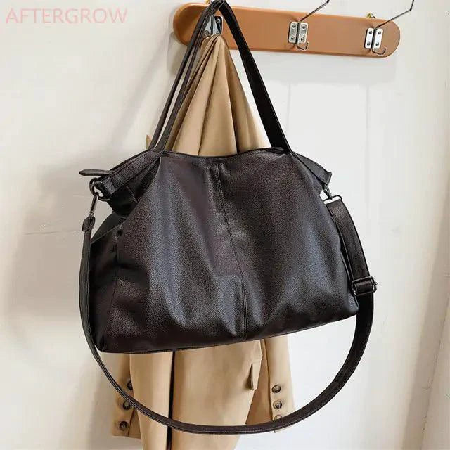 Elegant leather carryall bag by MANDOTOS with sturdy handles and sleek design, perfect for daily use and stylish outings.