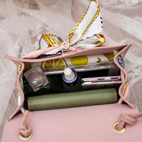 Elegant leather handbag and matching scarf by MANDOTOS, featuring stylish design and premium craftsmanship.