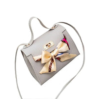 Elegant leather handbag and matching scarf from MANDOTOS, featuring stylish design and high-quality materials.