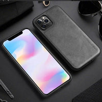Elegant leather iPhone shield by MANDOTOS showing a stylish brown protective phone case with smooth leather texture.