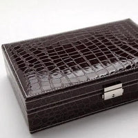 Elegant leather vanity case by MANDOTOS with a sleek design and leather handle, perfect for travel and organization.
