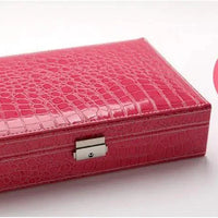 Elegant leather vanity case by MANDOTOS with a sleek design, featuring a sturdy handle and spacious interior for beauty essentials.