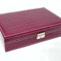 Elegant leather vanity case by MANDOTOS with a structured design and brass hardware, ideal for storing beauty essentials.