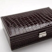 Elegant leather vanity case by MANDOTOS with a sleek design, featuring a sturdy handle and classic craftsmanship.