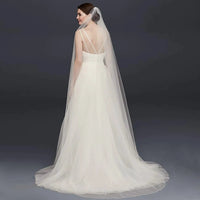 Long flowing wedding veil by MANDOTOS, ElegantBride V14 with delicate lace edging and soft tulle fabric for bridal elegance.