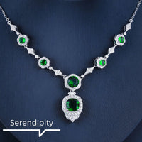 Mandotos Emerald Elegance white gold necklace featuring a central emerald gemstone and delicate chain for sophisticated style.