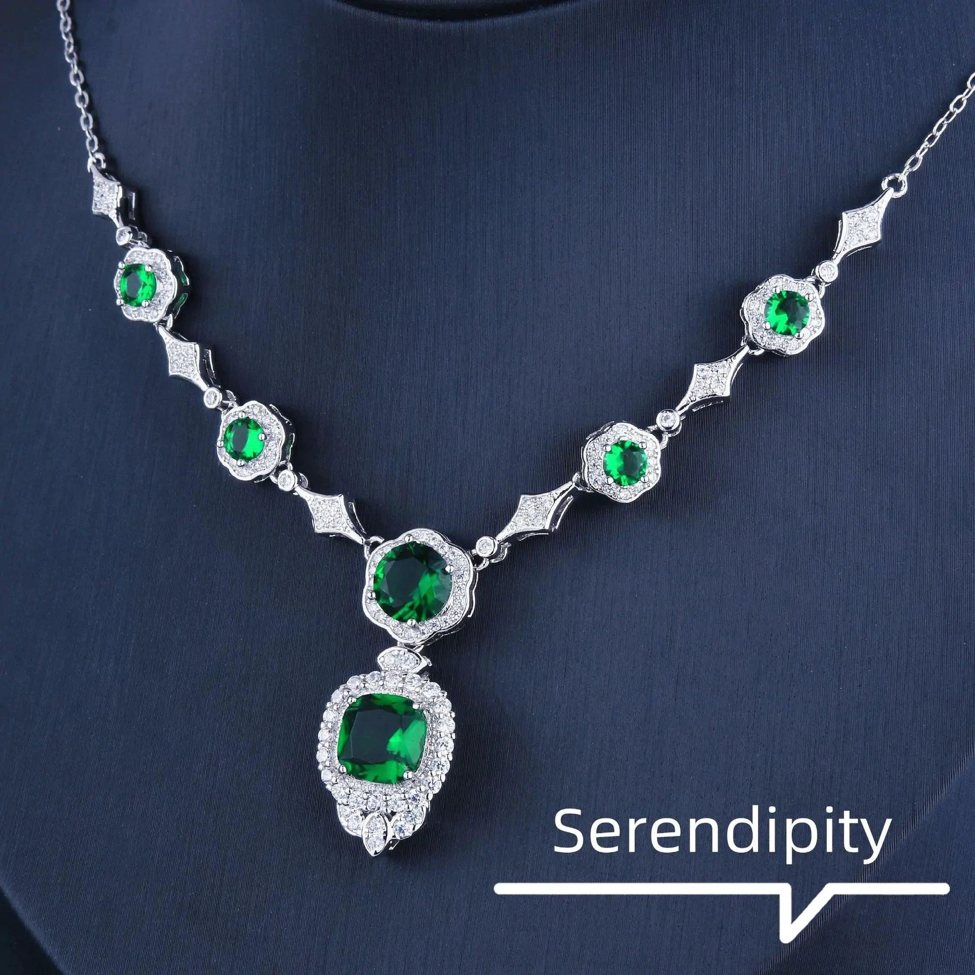 Emerald Elegance white gold necklace featuring a central emerald gemstone and intricate design by MANDOTOS.