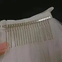 Ethereal double-tiered bridal veil by MANDOTOS, featuring delicate lace and flowing tulle for wedding ceremonies.
