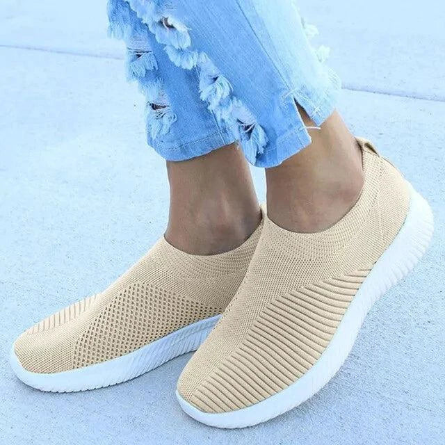 Mandotos flat knitted shoes in neutral color, showcasing their comfortable, stylish slip-on design with textured knit upper.