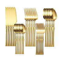 Mandotos Gold Glamour 30-piece dinner set with elegant gold accents, including plates, bowls, and serving dishes on a white background.
