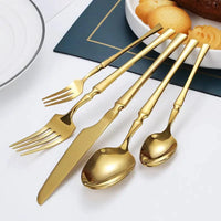 Gold Glamour 30-piece dinner set by MANDOTOS featuring elegant plates, bowls, and mugs with a luxurious gold finish.