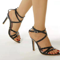Pair of golden strappy stiletto pumps by MANDOTOS featuring sleek design and high heels, perfect for elegant occasions.