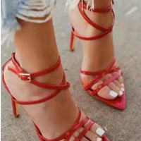Golden strappy stiletto pumps by MANDOTOS with thin heel and elegant design, perfect for formal or evening wear.