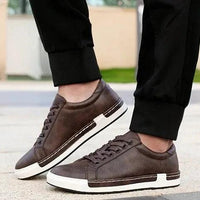 Mandotos handmade men's casual closed-toe trainers showing black leather upper and comfortable sole detail.