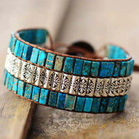 Handmade triple-layer natural stone bracelet by MANDOTOS featuring polished stones and adjustable cord.