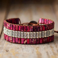 Handmade triple-layer natural stone bracelet by MANDOTOS featuring smooth, rounded stones in earthy tones.