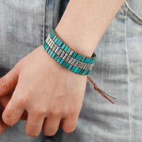 Handmade triple-layer natural stone bracelet from MANDOTOS featuring smooth, polished stones in earthy tones.