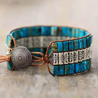 Handmade triple-layer natural stone bracelet by MANDOTOS featuring smooth, round stones in earthy tones and adjustable cord.