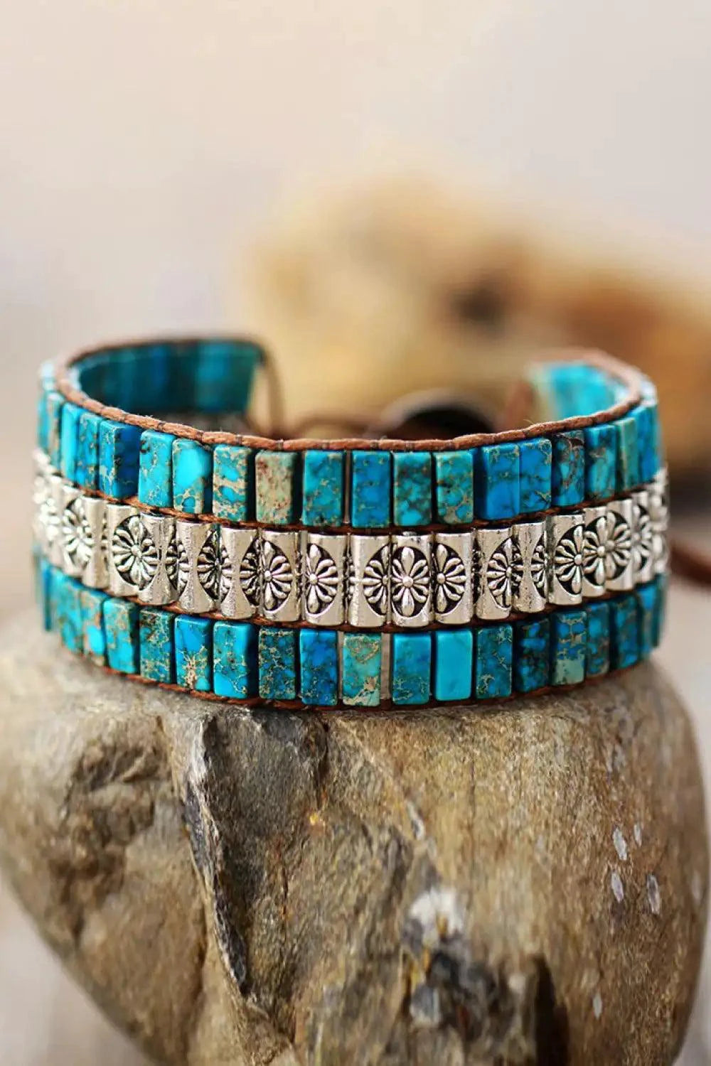 Handmade triple-layer natural stone bracelet by MANDOTOS featuring polished stones and adjustable cord.