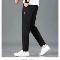 Mandotos Ice Silk men's summer pants in black and gray with straight leg fit, breathable elastic fabric, suitable for casual or outdoor wear.