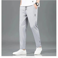 Mandotos Ice Silk men's summer casual pants in black and gray, featuring a breathable, elastic, straight-leg design.