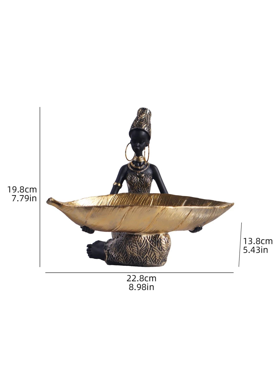 African girl holding a plate sculpture by MANDOTOS INTERNATIONAL, vintage decorative storage ornament for home or office decor.