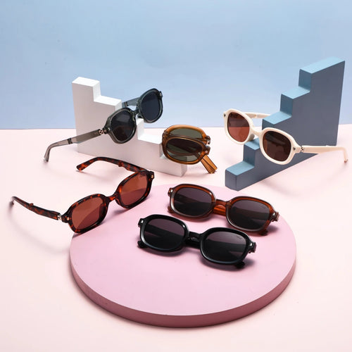 Black foldable retro oval sunglasses with UV400 polarized lenses and TR90 frame, unisex style by MANDOTOS INTERNATIONAL.
