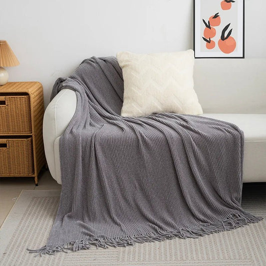Knitted wool throw blanket with tassels by MANDOTOS INTERNATIONAL, cozy home decor and travel blanket in soft, warm wool.