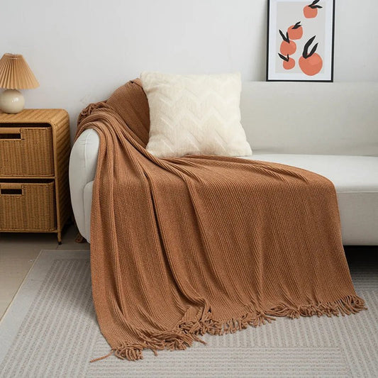 Knitted wool throw blanket with tassels by MANDOTOS INTERNATIONAL, cozy home decor and travel accessory in soft, warm fabric.