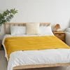Knitted wool throw with tassels from MANDOTOS INTERNATIONAL, cozy home decor and travel blanket in soft, warm fabric.