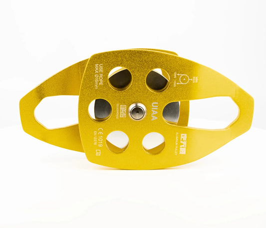 Mandotos International custom single fixed mountaineering pulley for outdoor climbing, shown with climbing ropes in a travel kit setup.