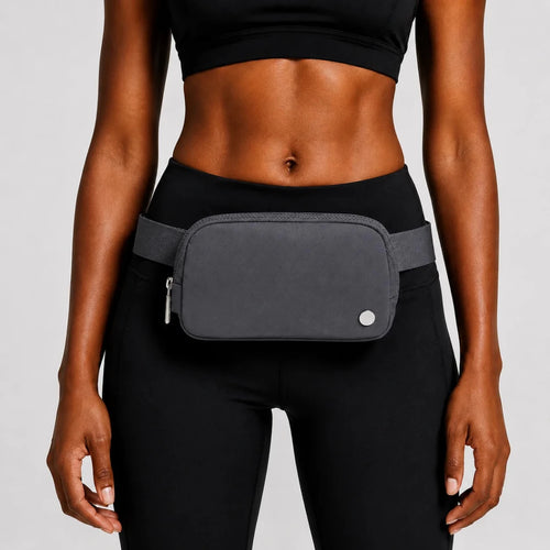 Mandotos International lightweight women's waist bag for running and travel, shown in black with adjustable strap and secure zip closure.