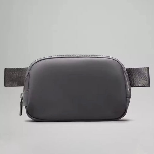 Mandotos International premium lightweight women’s waist bag for running and travel, shown in black with adjustable strap.