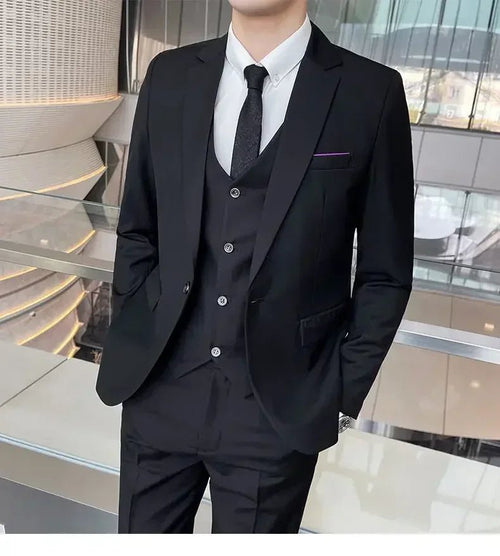 Mandotos International men's formal business suit with blazer, vest, and pants in black, styled for professional or banquet occasions.
