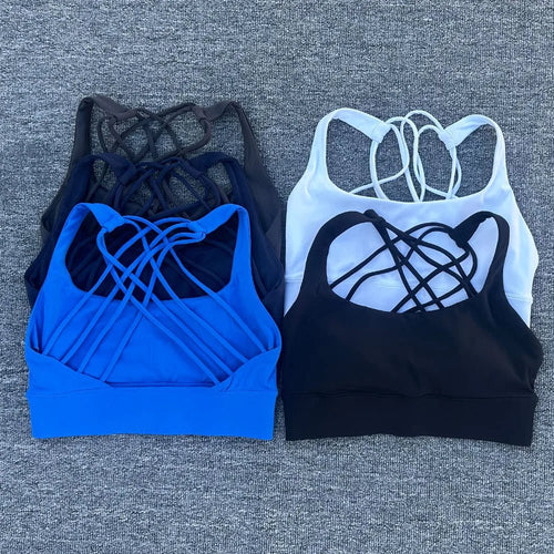 Women's shockproof yoga crop top and anti-sweat gym sports bra by MANDOTOS INTERNATIONAL, shown on a model, designed for active workouts.