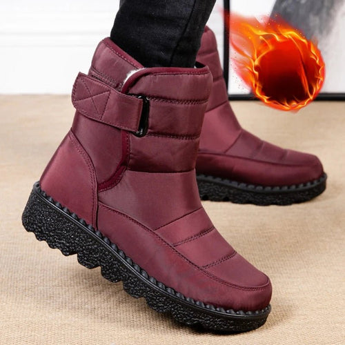 Women's waterproof winter snow boots from MANDOTOS INTERNATIONAL with non-slip soles and warm platform design, ankle height.