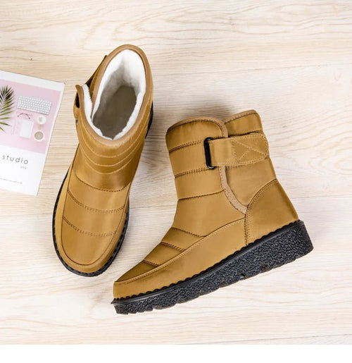 Women's waterproof winter snow boots by MANDOTOS INTERNATIONAL with non-slip soles, warm lining, and platform heel.