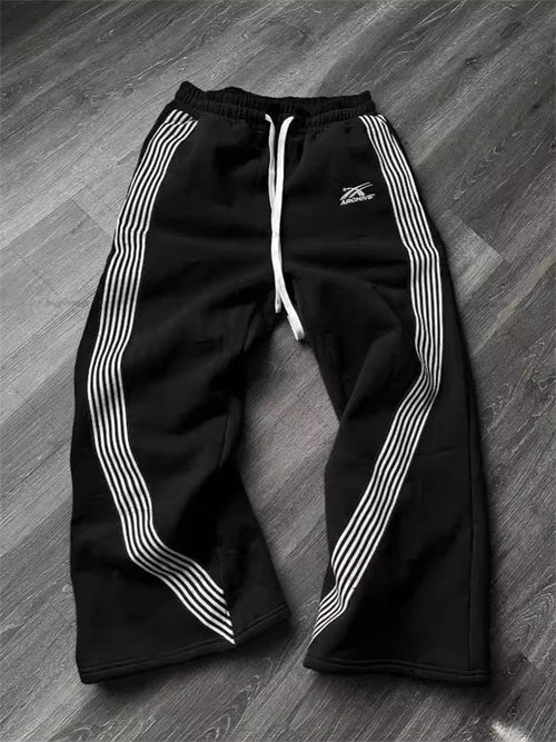 Y2k embroidered black and gray camouflage tactical jogger pants by MANDOTOS INTERNATIONAL, with drawstring waist and functional design.