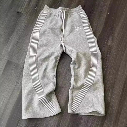 Black and gray Y2K embroidered tactical jogger pants with camo accents, drawstring waist, suitable for men and women, casual and functional.