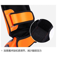 Mandotos kickboxing shin guards for Muay Thai, black leg protectors with padding for training and competition.