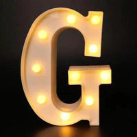 Mandotos luminous letter lights spelling out a word, illuminated with warm glow, ideal for decorative room lighting or events.